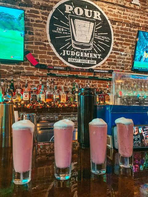 Pour Judgement badge on the brick wall above the bar