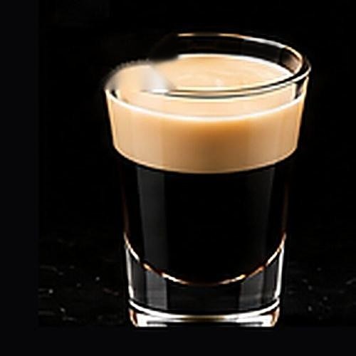 Baby Guinness classic shot on a dark bar background
