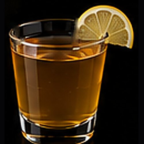 Hot Toddy classic cocktail on a dark bar background