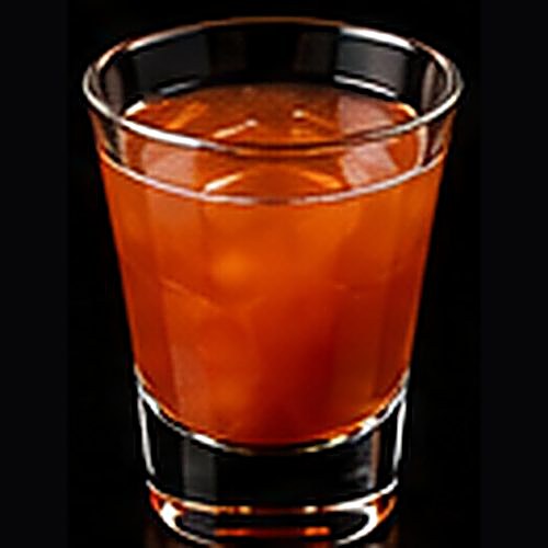 Jungle Bird classic cocktail on a dark bar background