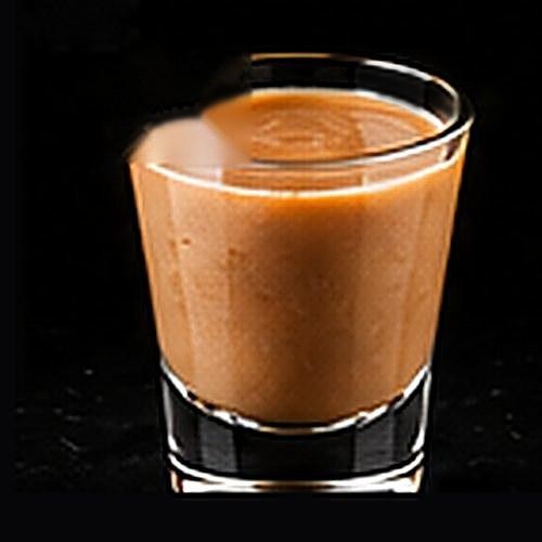 Mudslide classic cocktail on a dark bar background