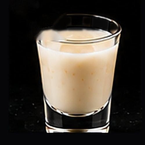 Piña Colada classic cocktail on a dark bar background