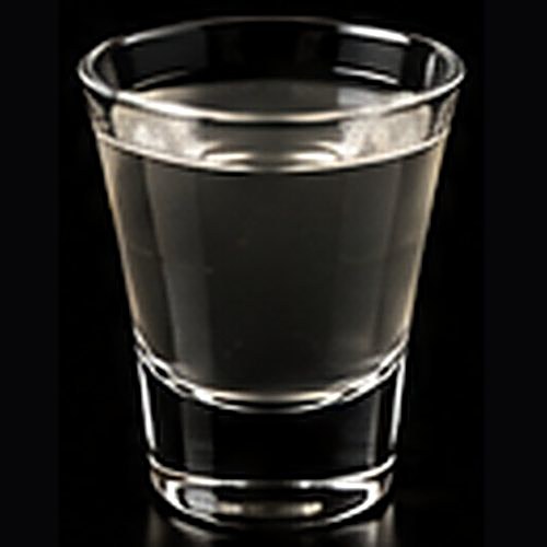 Vesper classic cocktail on a dark bar background