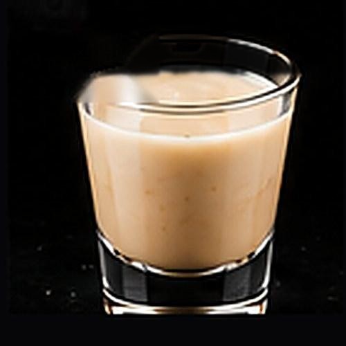 White Russian classic cocktail on a dark bar background